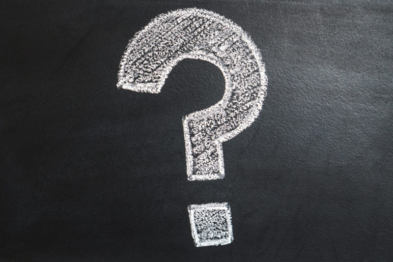 Image of a question mark drawn on a blackboard.